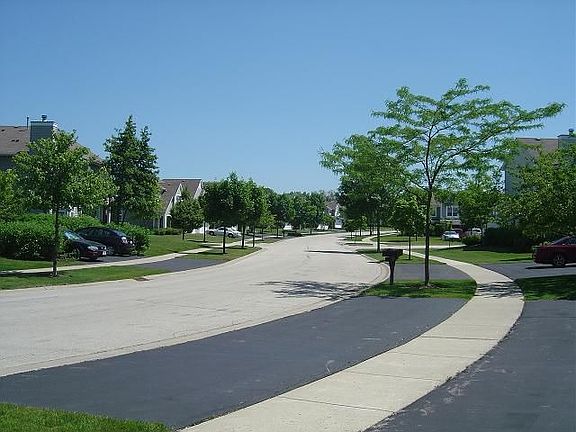 Wide Driveway and Professional Landscaping