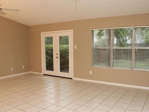 Huge family room with wall of windows overlooking one of the largest lots in the neighborhood.