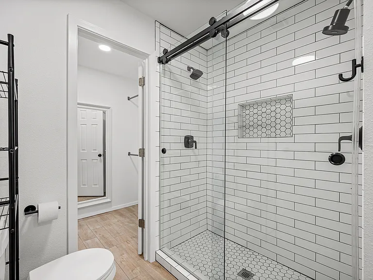 Primary bathroom upstairs with access to the larger walk-in closet. Two shower heads with good water pressure.