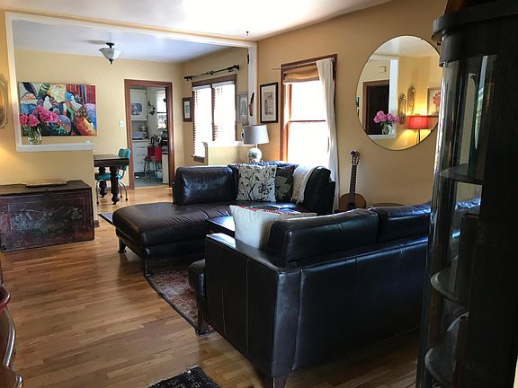 Living room with dining room and kitchen in background