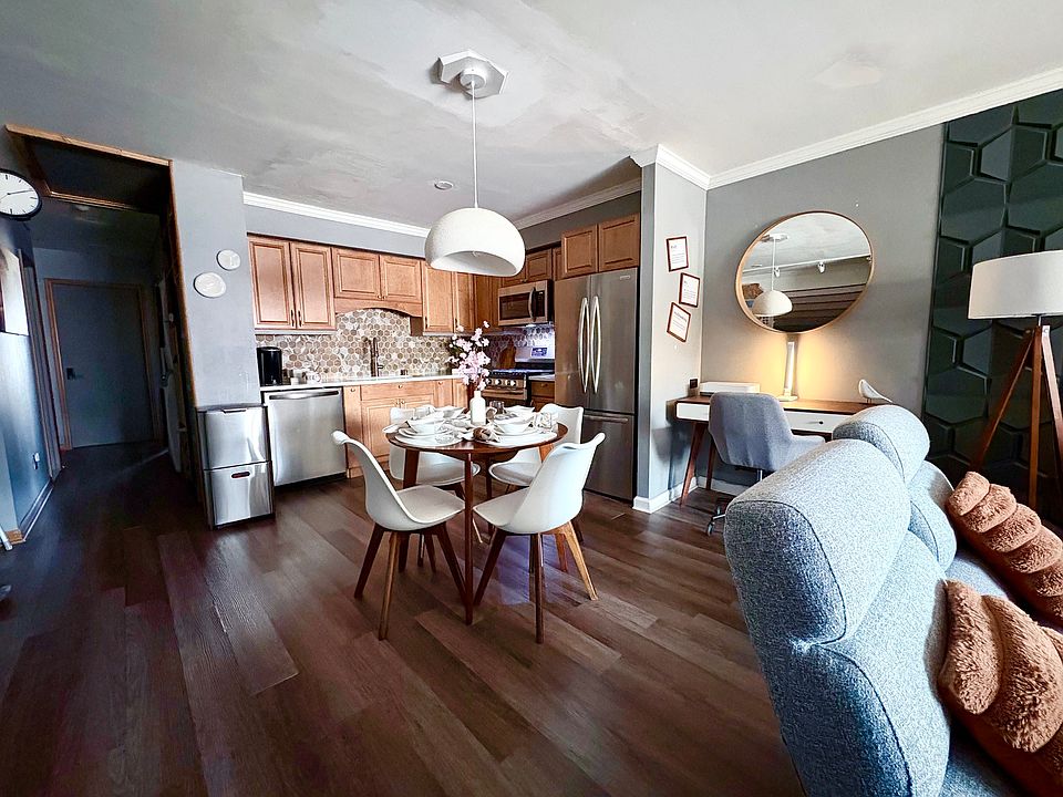 Full view of kitchen, dining area and central work space.