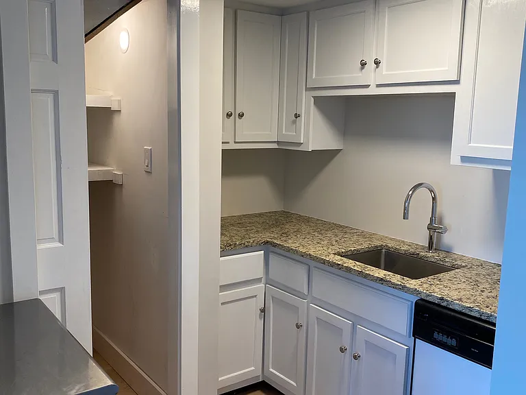 Kitchen with large pantry and moveable island.