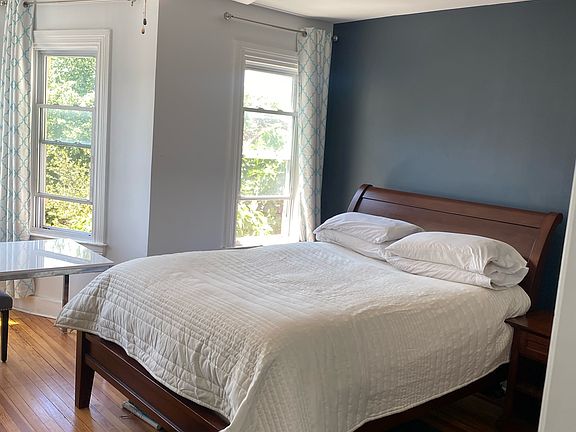 Upstairs master bedroom with bay windows and natural light