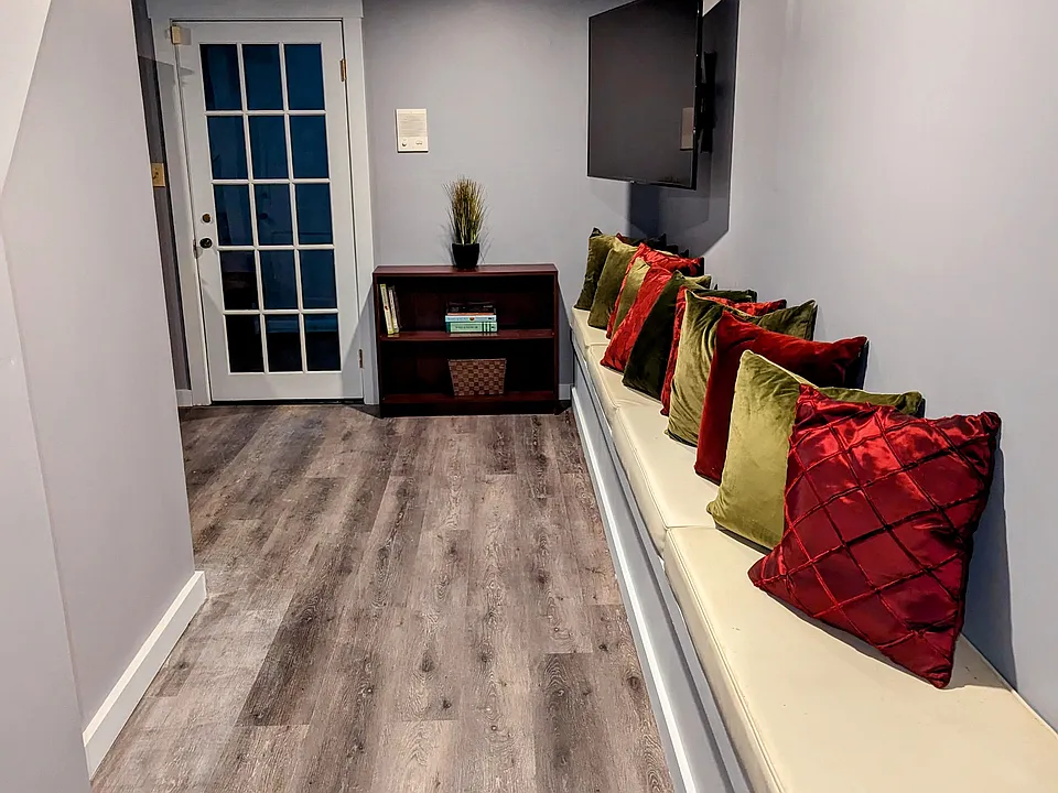 Hallway Leading to Living Room from Kitchen, Large Bedroom and Laundry.
