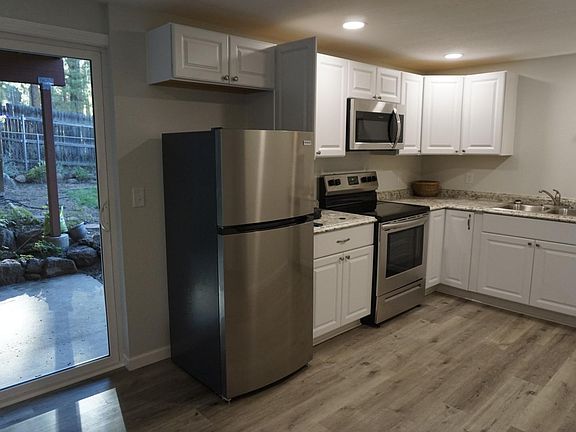 Kitchen and sliding glass door leading to private covered patio. (This is the main entrance for tenants). Total size for Kitchen/Living room is about 375 sq feet.