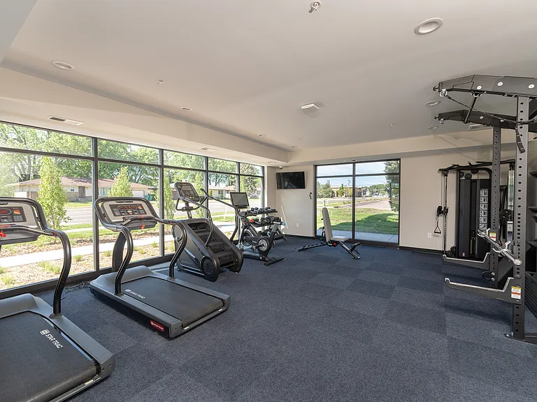 A modern Fitness Center equipped with cardio machines for daily workouts.