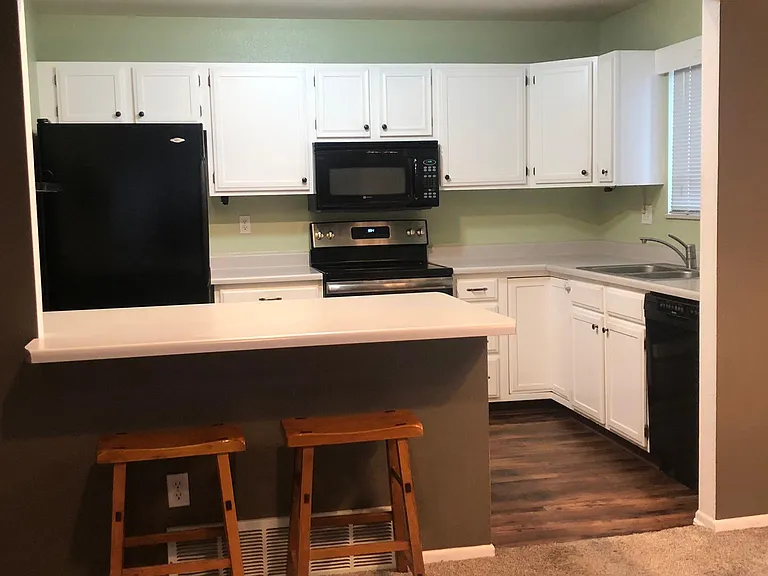 Open Kitchen to Livingroom with Two Counter Height Stools.