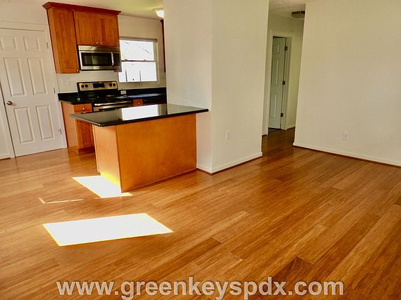 Living room with view into kitchen