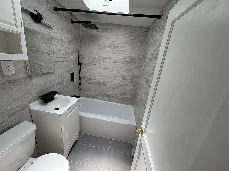 Fully Renovated Bathroom With Modern Tile & Skylight