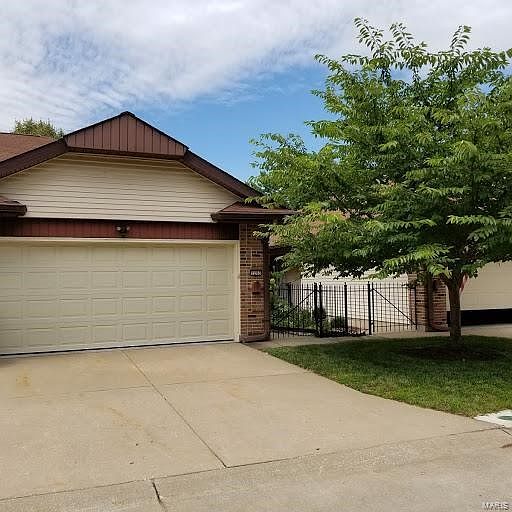 Attractive front with 2 car garage and courtyard entrance