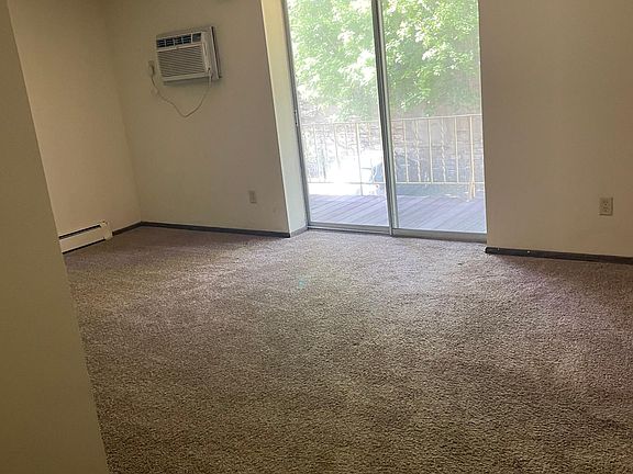 Large studio room with walk out deck overlooking garden area in back.