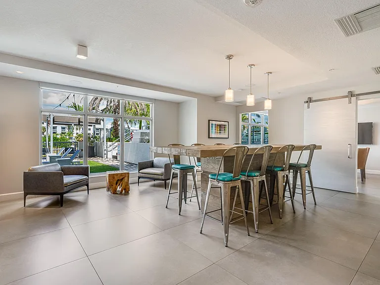 Clubhouse Community Room with Long Table and Outdoor Access