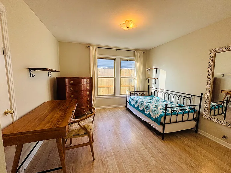 Spacious bedroom with large windows and plenty of natural light.