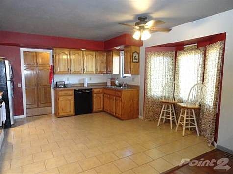 Large kitchen with breakfast area and ceiling fan.