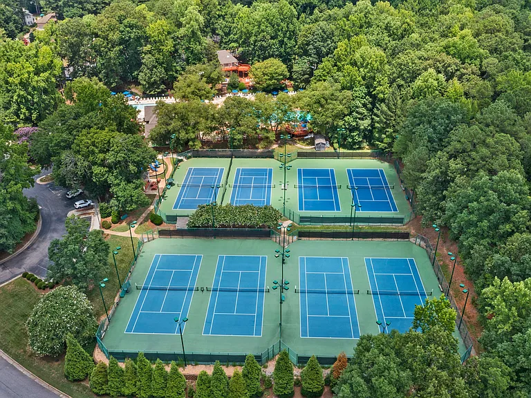Well-maintained tennis courts among the community amenities.