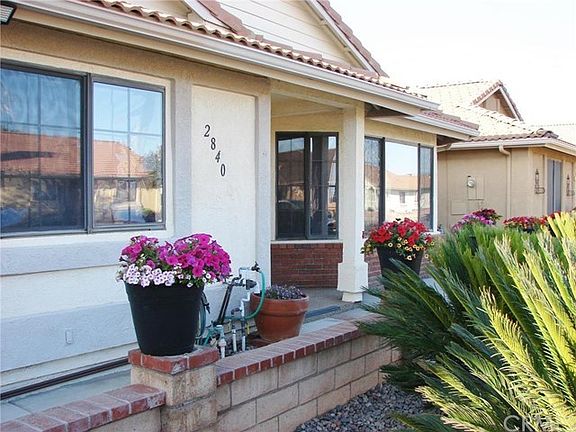 ANOTHER VIEW of FRONT PATIO & ENTRY. DUAL PANE WINDOWS, STUCCO SIDES & TILE ROOF PLUS EXCELLENT INSULATION & CEILING FANS IN EVERY ROOM AND SOLAR SHADES ON FRONT WINDOWS OFFER EXCELLENT/ENERGY BUDGET FRIENDLY LIVING. PLUS++NEWER UPGRADED AC/HEAT SYSTEM.