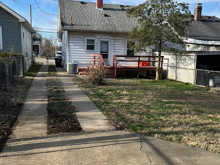 Large, fully fenced back yard with deck and exterior entrance to basement.