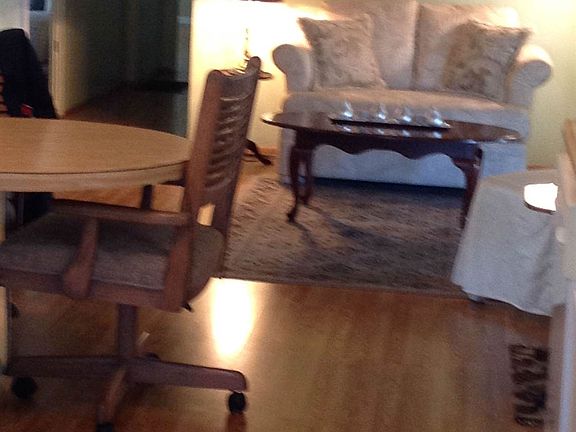 Living area with laminate flooring and tastefully decorated