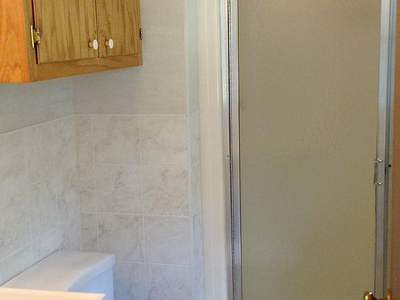 Master bath has a walk-in shower with extra storage area above commode. Nice cabinets here!