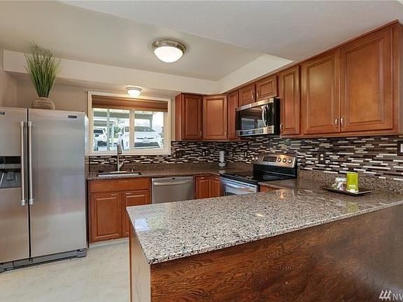 Updated kitchen with granite counter tops and stainless stee
