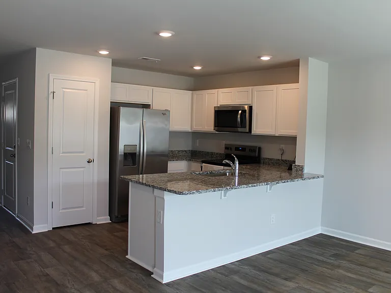 View of Kitchen with granite countertops and Pantry