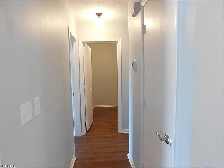 Going down the hall, you will find primary bedroom on left side, extra storage room or office option. Turn to the right you will have 2nd bathroom with laundry closet across from it and then 2nd bedroom at end of hall.