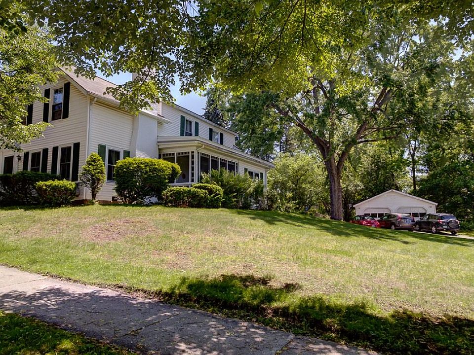 Expansive side lawn showing detached two car garage