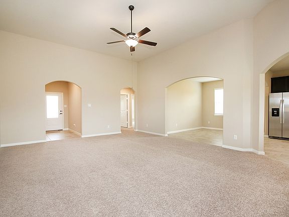 Eye-catching archways set apart the spacious family room at the heart of this home.