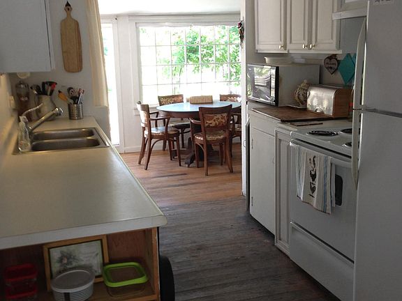View through galley kitchen to garden room eating area.