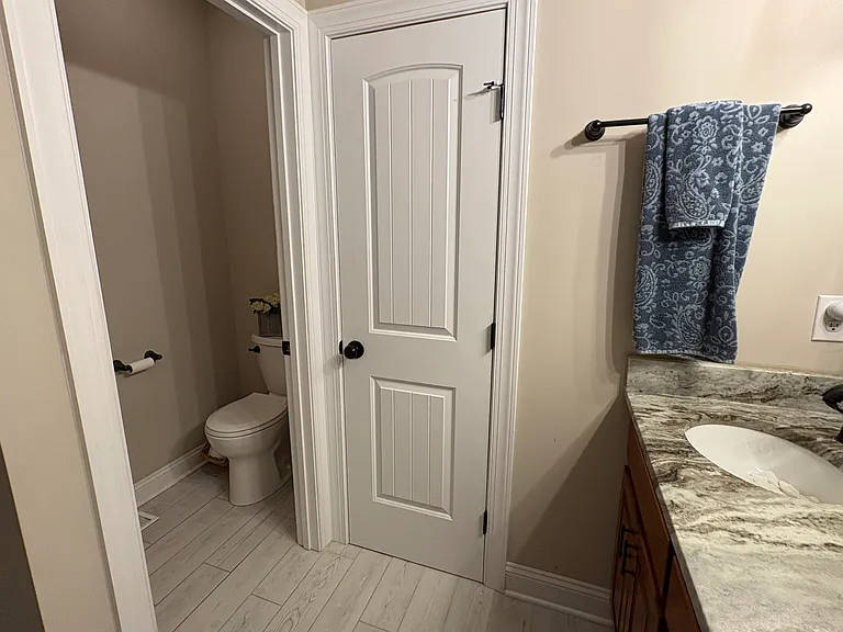 There is a double sink with coordinating granite and a private toilet room and linen closet.