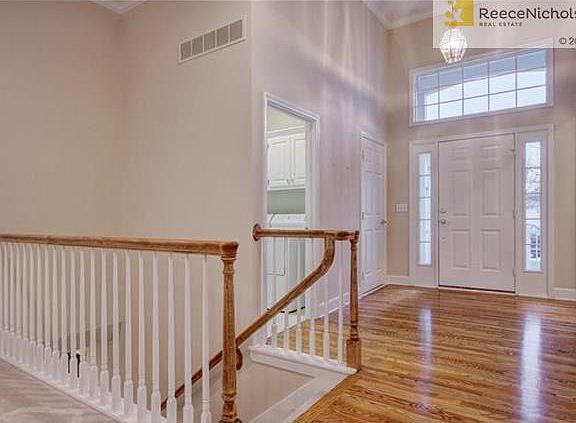 Large foyer with hardwoods, lots of natural lights, and high ceilings. Laundry room and coat closet to your right upon entry. Stairs to lower level.