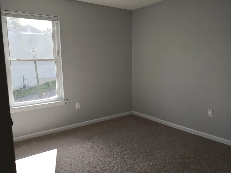 2nd bedroom with new carpet and closet