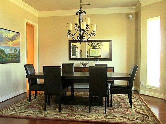 Lovely dining room with double crown molding, bay window and rich wood floors!