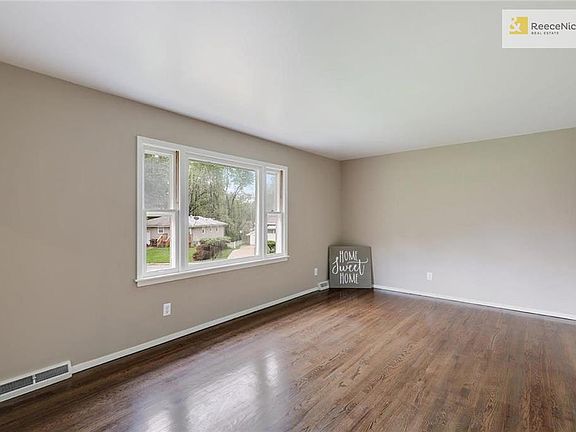 Enter into the large living room with lovely picture window. The hardwood floors throughout the home have just been re-finished.