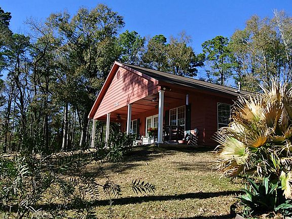 Home is on the middle of 3 lots that offers you space to move around