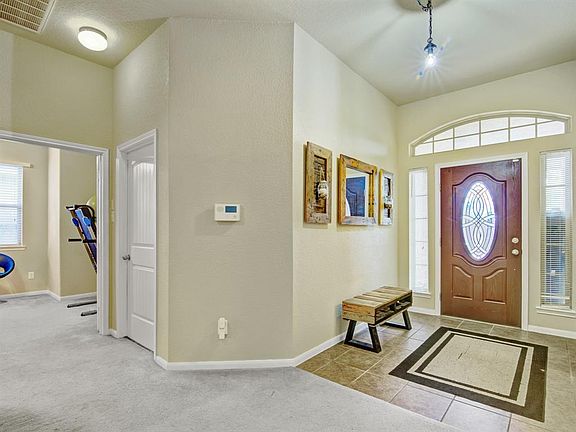Open entryway with garage entrance on the left.