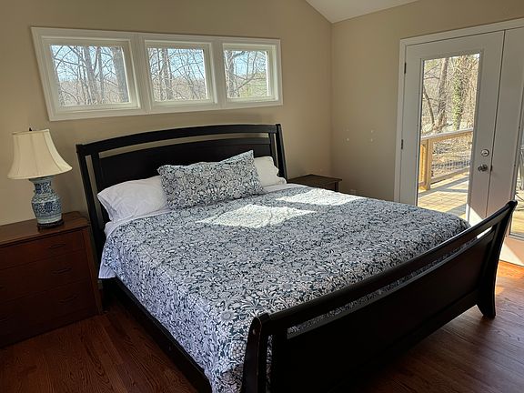 Primary bedroom- king size bed. Glass french doors that open to deck. Private bathroom.