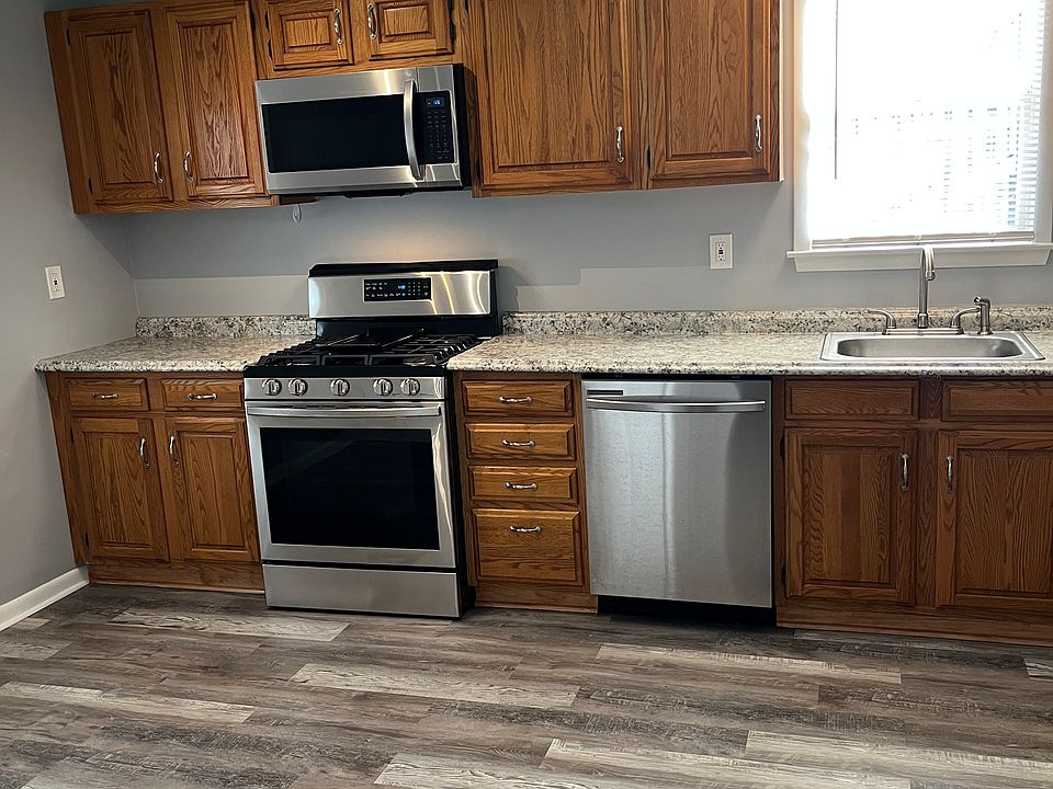 Large kitchen with gas stove and microwave.