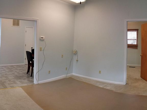 Front entrance of home takes you into the living room. From living room to the right is the first bedroom and left takes you into dining room.