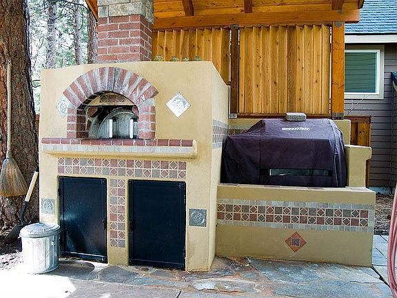 Built in pizza oven and grill with custom arbor.