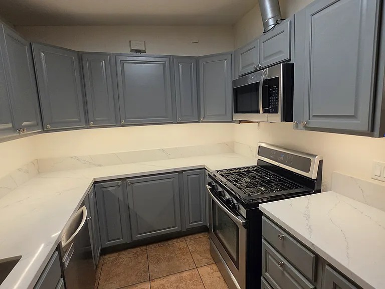 Kitchen with dishwasher, gas stove, and microwave.