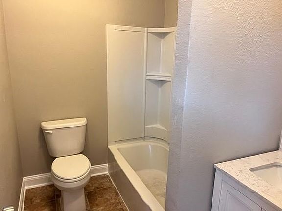 Primary bathroom with tub and single vanity.