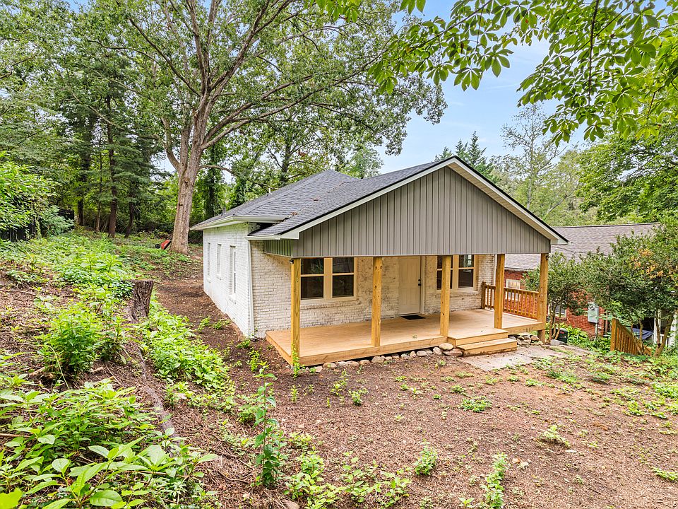 Front of home. New large covered front deck. Driveway is to the right of the home.