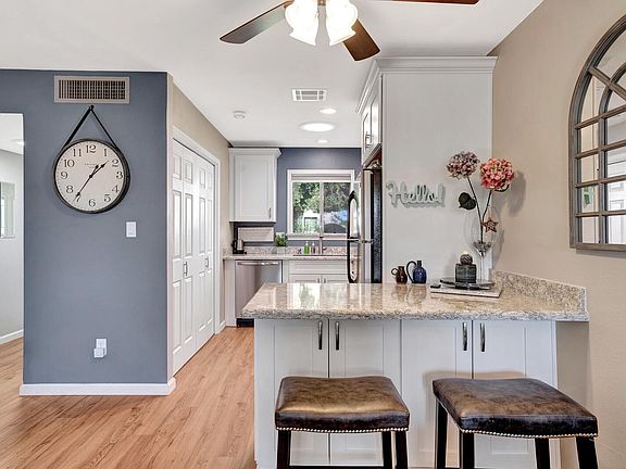 Dining area with a fan & light remote control, kitchen with a sunlight tube.