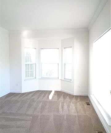 Formal Living Room with bay window and crown molding