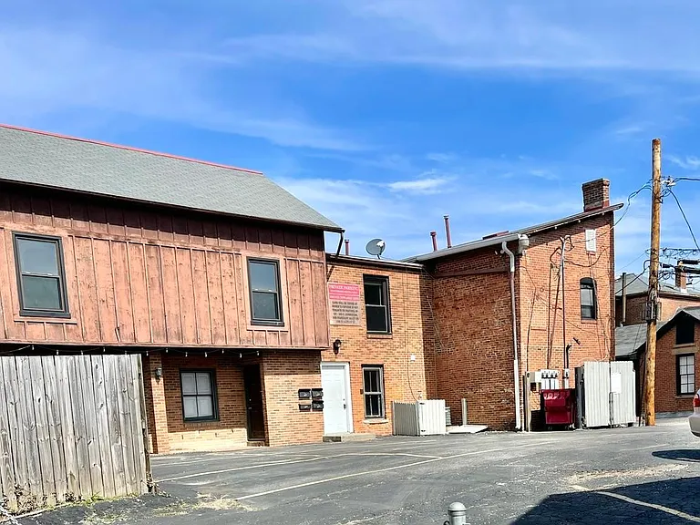 Exterior of back side of building, tenant parking lot.