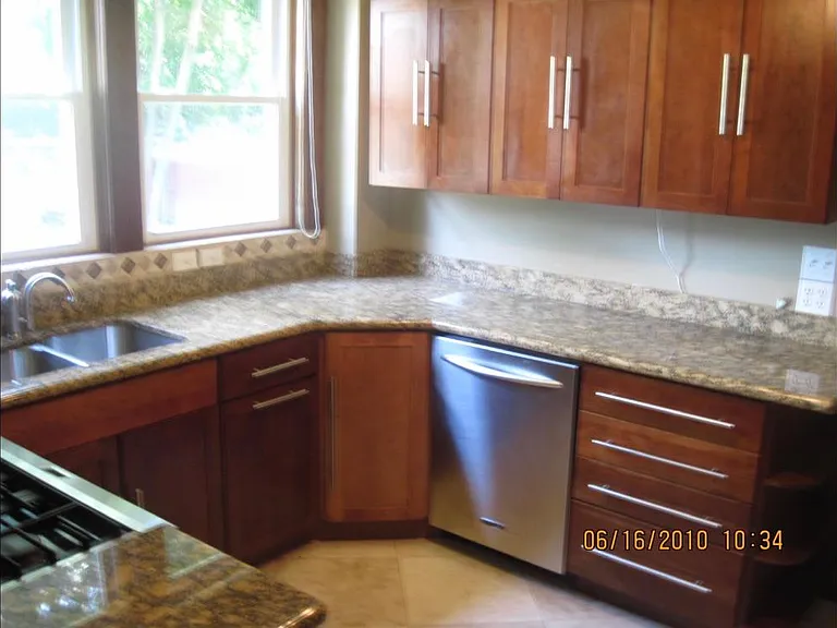 KRAFTMAID Cherry Cabinets with granite countertops & KitchenAid stainless steel appliances. Two large windows overlooking huge yard