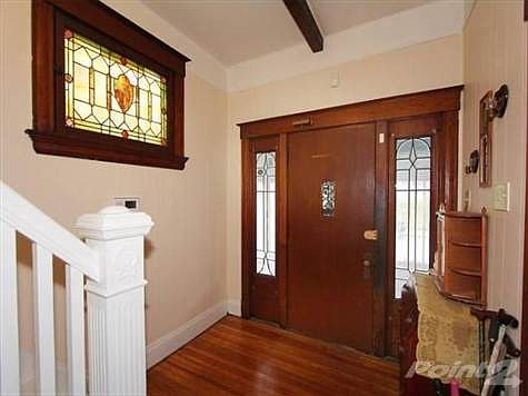 Welcome your friends and family into this large foyer with a beamed ceiling, stained glass window and original front door!  The bannisters have wonderful the wonderful historic quality you love in these homes and nice wooden steps to access the upstairs.  Their is an additional window in the stairway.