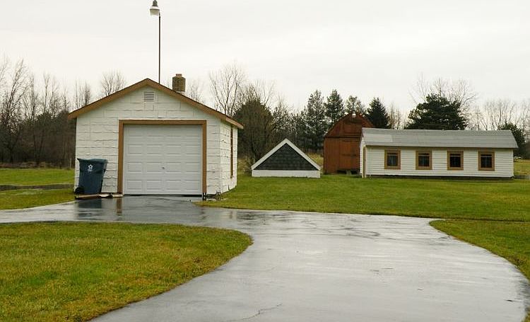 One car detached garage, chicken coop, and shed.