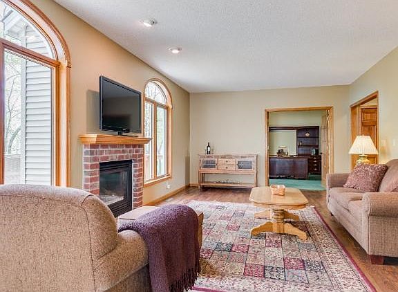 The Main Level Family Room is Perfect for Family Gatherings. Large Windows of the Private Lot w/Pond Views and Gas Fireplace.